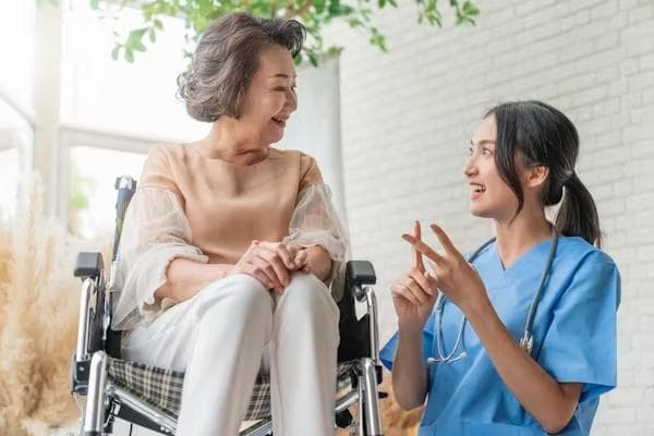 Nurse in conversation with a resident using a wheelchair